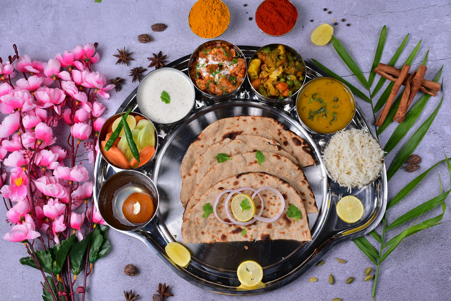 a plate of food on a table with flowers